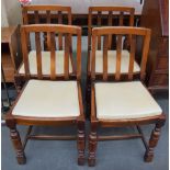 A set of four drop seat oak dining chairs with cream leather seats, turned legs,