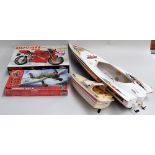 A Ducati motorbike kit, two powerboat models, a box of toys,