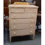 A tall white painted chest of drawers, with two short drawers over four long,