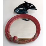 A Poole pottery dolphin and ceramic mirror with candle holder and floral decoration