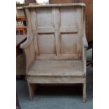 A stripped pine pew chair