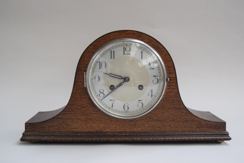 A wooden mantel clock with Arabic numerals to silvered chapter ring,