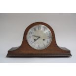 A wooden mantel clock with Arabic numerals to silvered chapter ring,