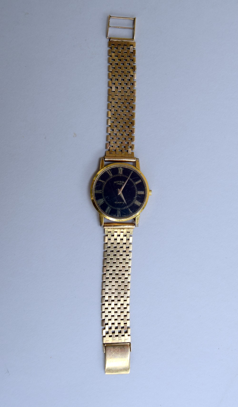 A gents quartz wrist watch by Rotary having Roman numeral dial to circular black face on a brick