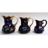 A set of three Masons ironstone "Mazarene" cobalt blue and gilt hand painted hydra shaped jugs,