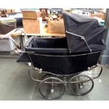 A substantial early 20th century coach built pram with fitted interior and folding hood