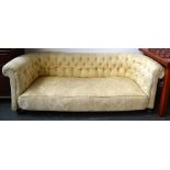 A Victorian style cream upholstered Chesterfield sofa