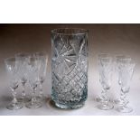 A cut glass vase and a set of eight cut and etched wine glasses