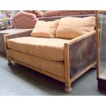 A two seater bergere sofa, suede and leather over an oak frame, from the estate of Jocasta Innes,