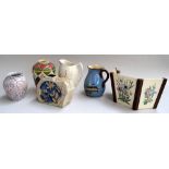 A mixed lot of ceramics including two jugs and two vases, a wall mounting planter,