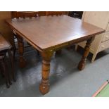 An oak dining table with extending leaves, on heavy turned legs, 84x106.