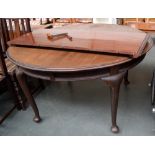 A mahogany extending circular dining table, raised on cabriole legs with pad feet on casters,