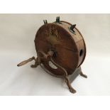 A Victorian circular oak knife polisher, with open ironwork base and S shaped handle,