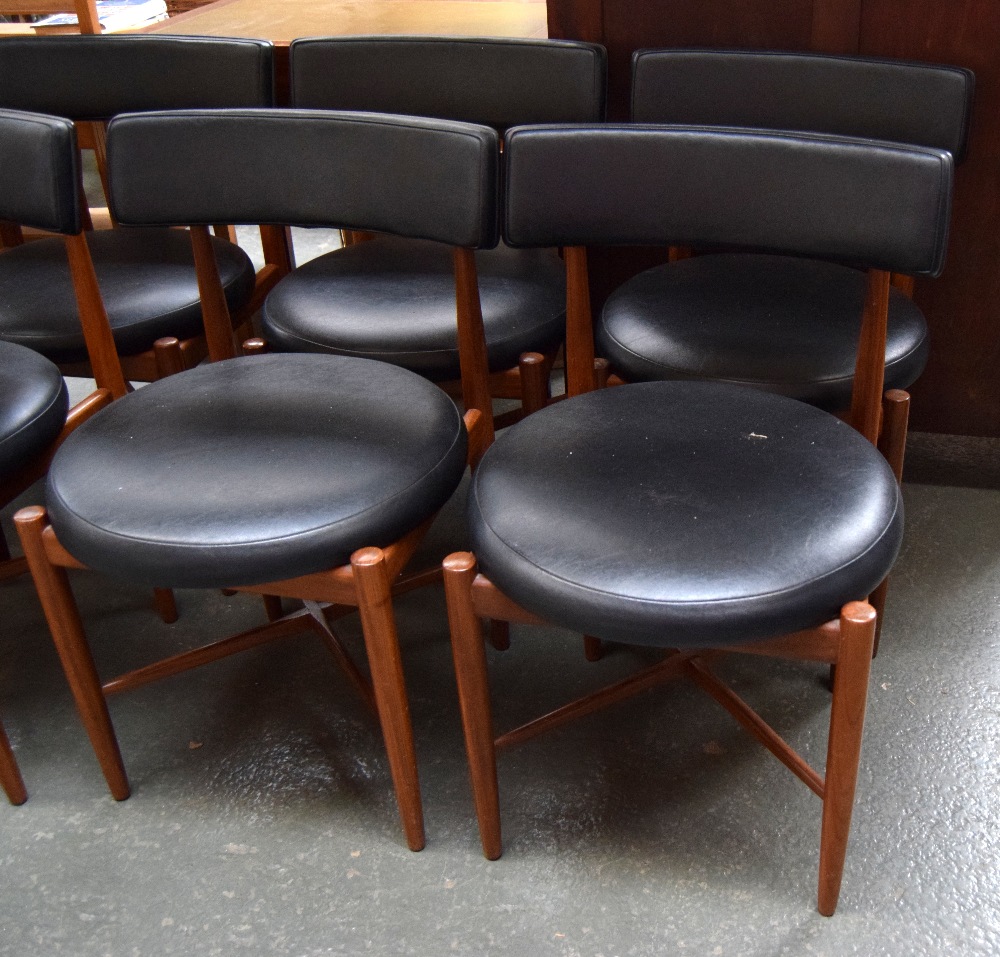 A set of four mid-century G Plan chairs with round leather seats and leather back,
