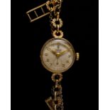 A LADIES 9CT GOLD TUDOR WATCH WITH 9CT GOLD ROLEX SIGNED INTEGRAL BRACELET CIRCA 1954, HALLMARK