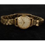 A LADIES 9CT GOLD OMEGA WRIST WATCH  CIRCA CHAMPAGNE DIAL WITH BUTTON MARKERS 18.35g Movement: