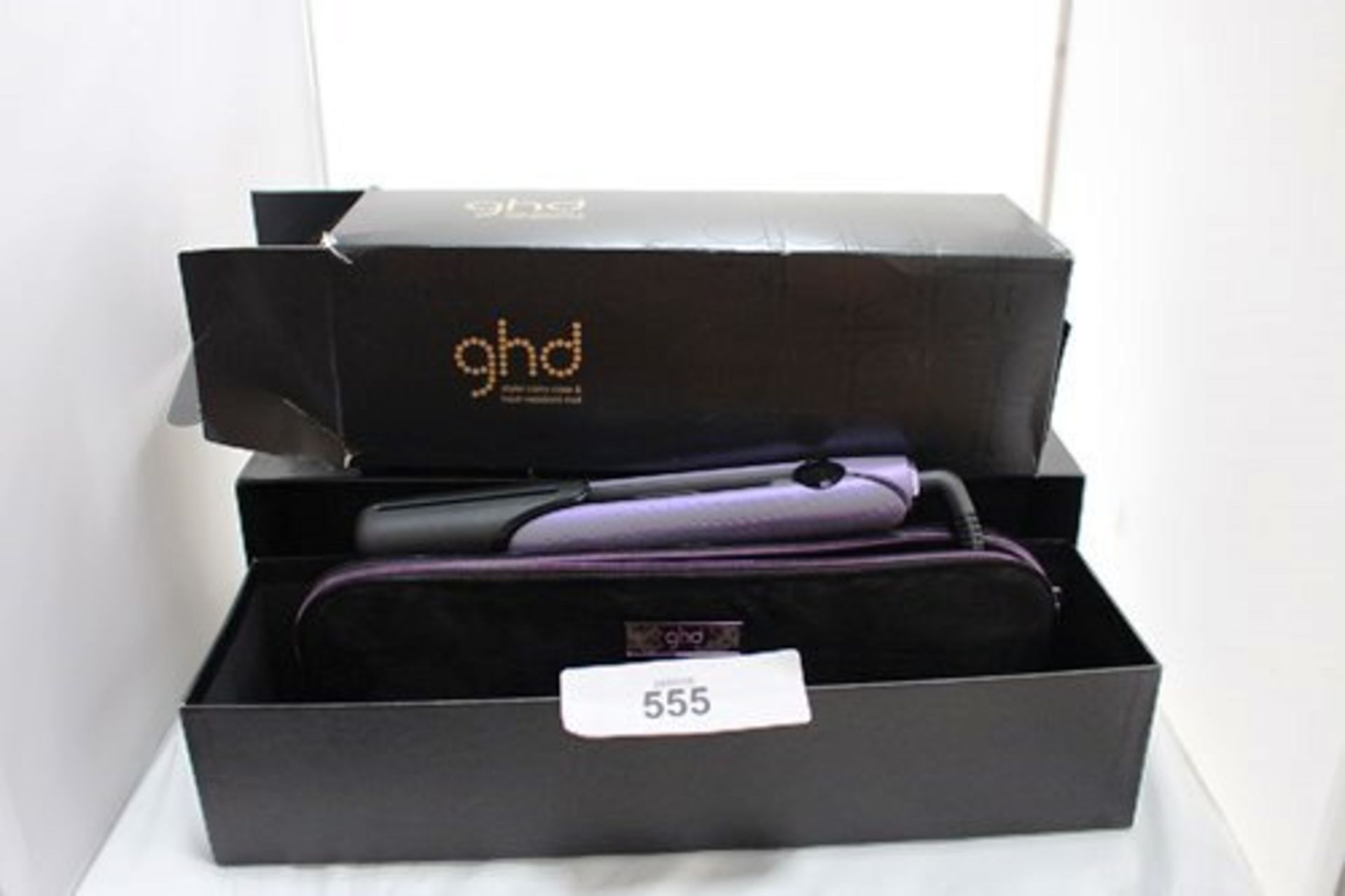 A pair of GHD V gold styler gift set straighteners, together with heat resistant bag and styler