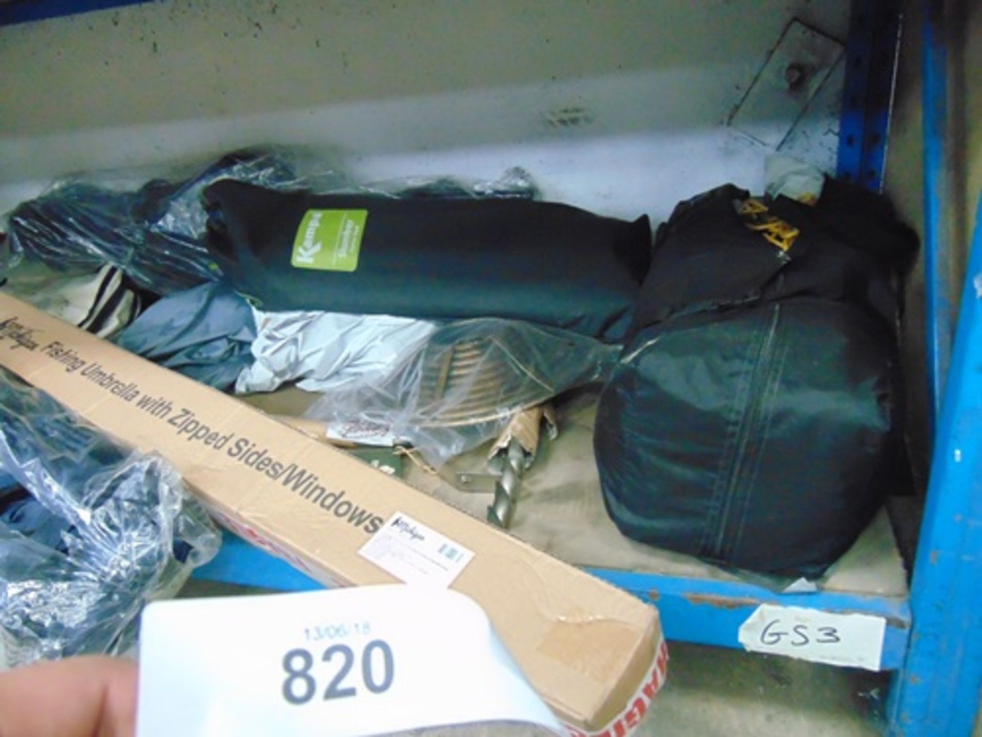 A shelf of outdoor/garden items including a fishing umbrella, camp bed, sunblaster horticultural