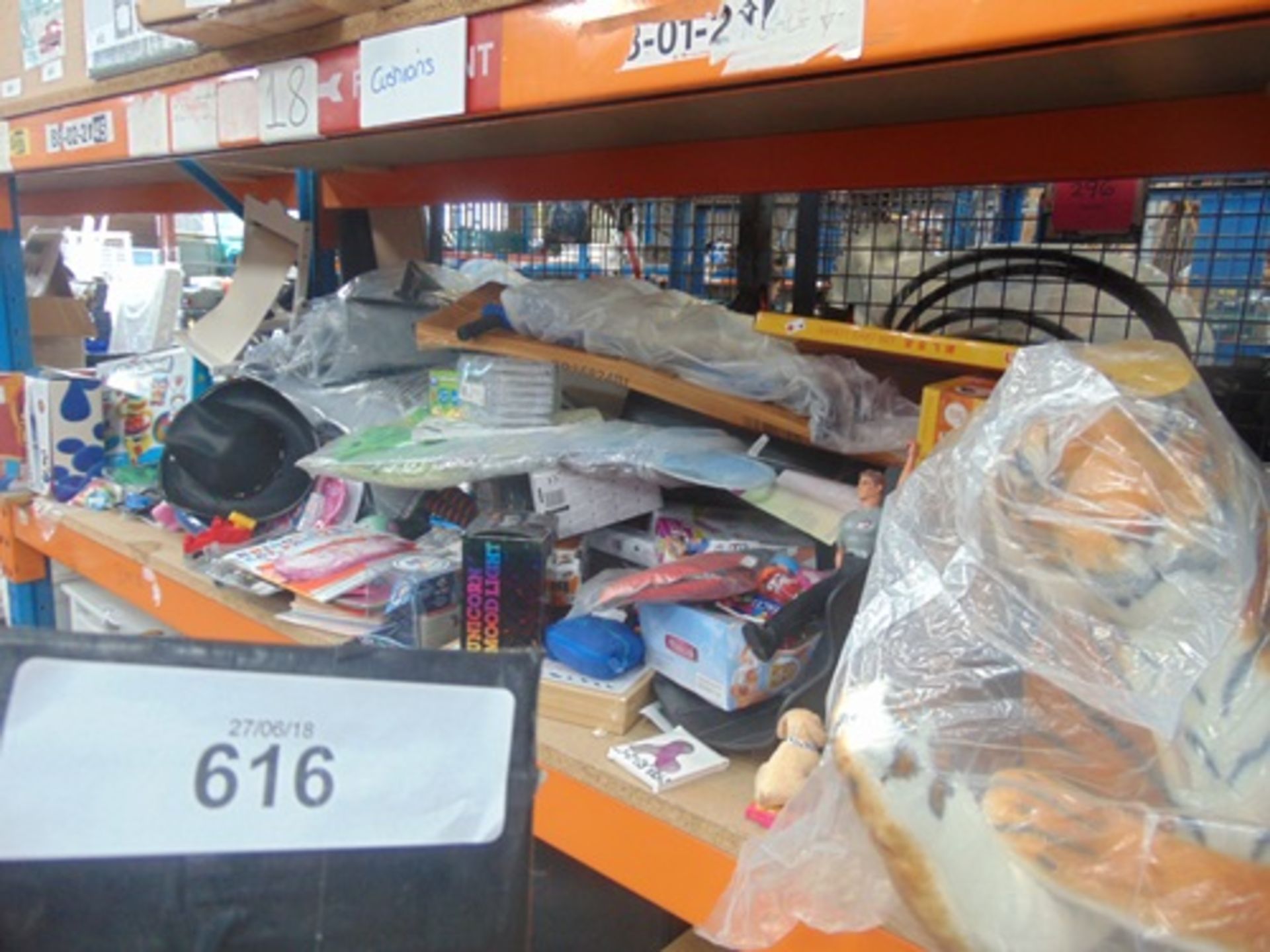 A shelf of children's toys including large plush tiger, Electric Audi car, board games, pogo stick