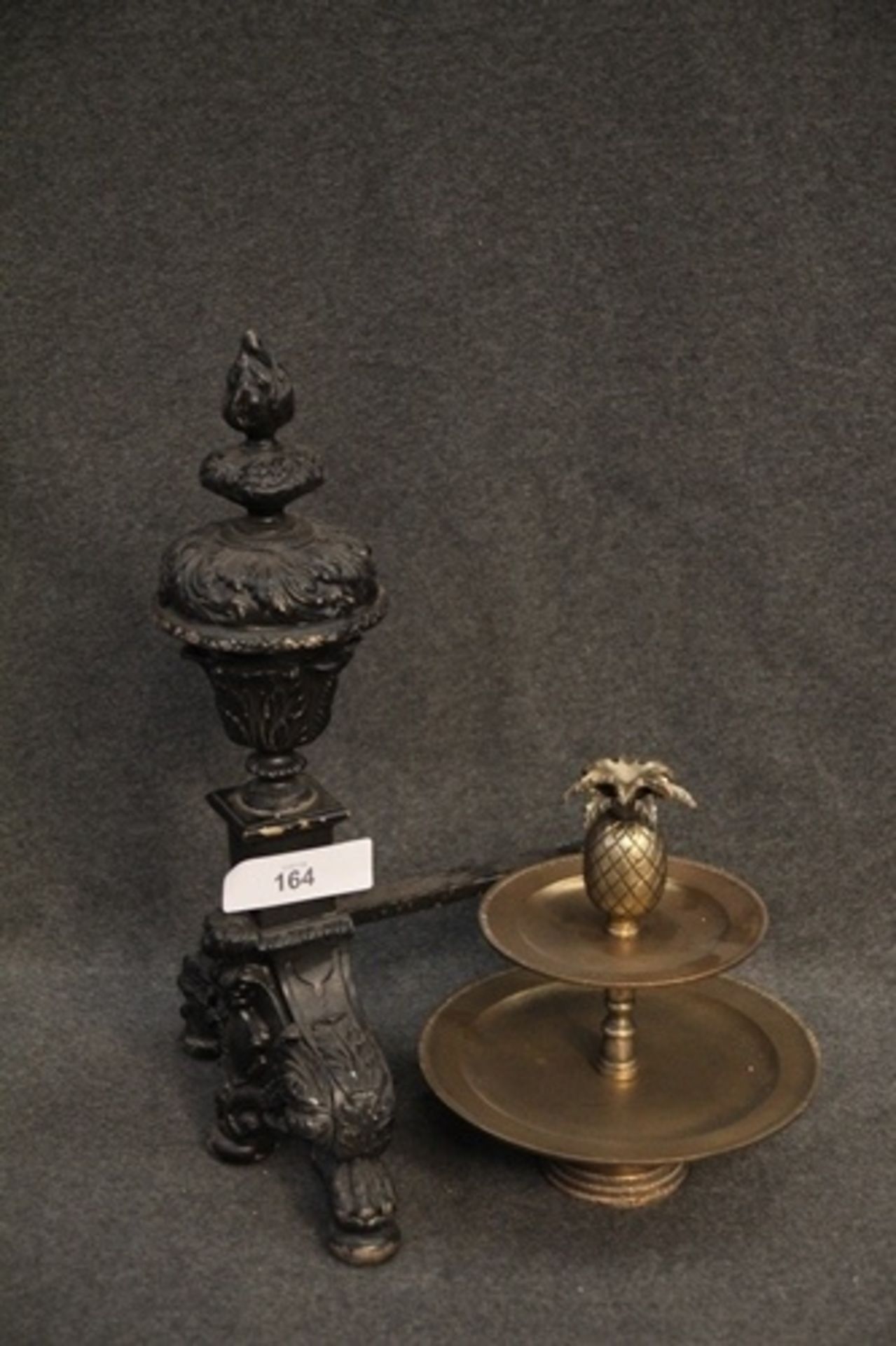 A single repro fire iron, 55 x 33 x 32cm and brass 2 tier stand with pineapple top piece