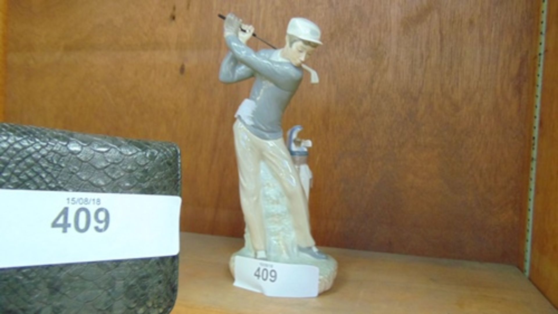 A Lladro figure of a golfer swinging a club, incised mark 4824, 28cm high (C28)