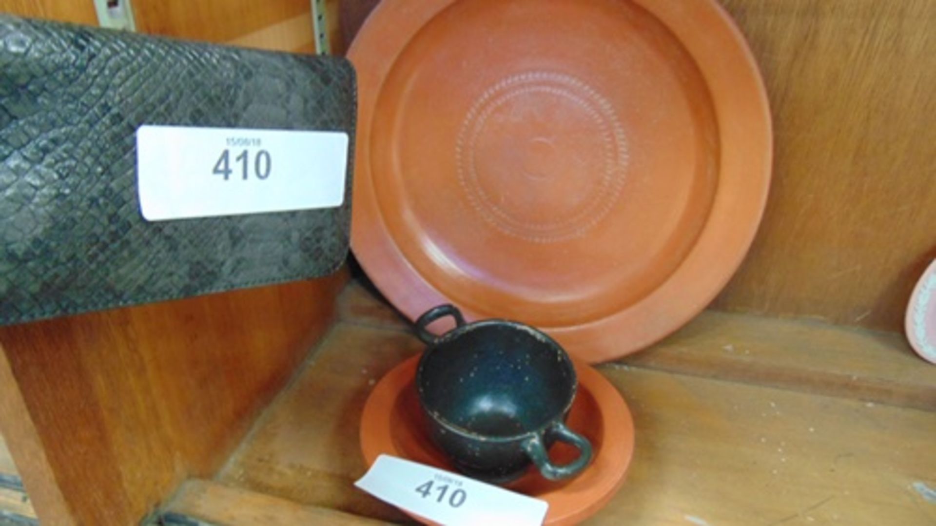 Earthenware circular dish with double ring marked decoration, a smaller bowl and a black earthenware