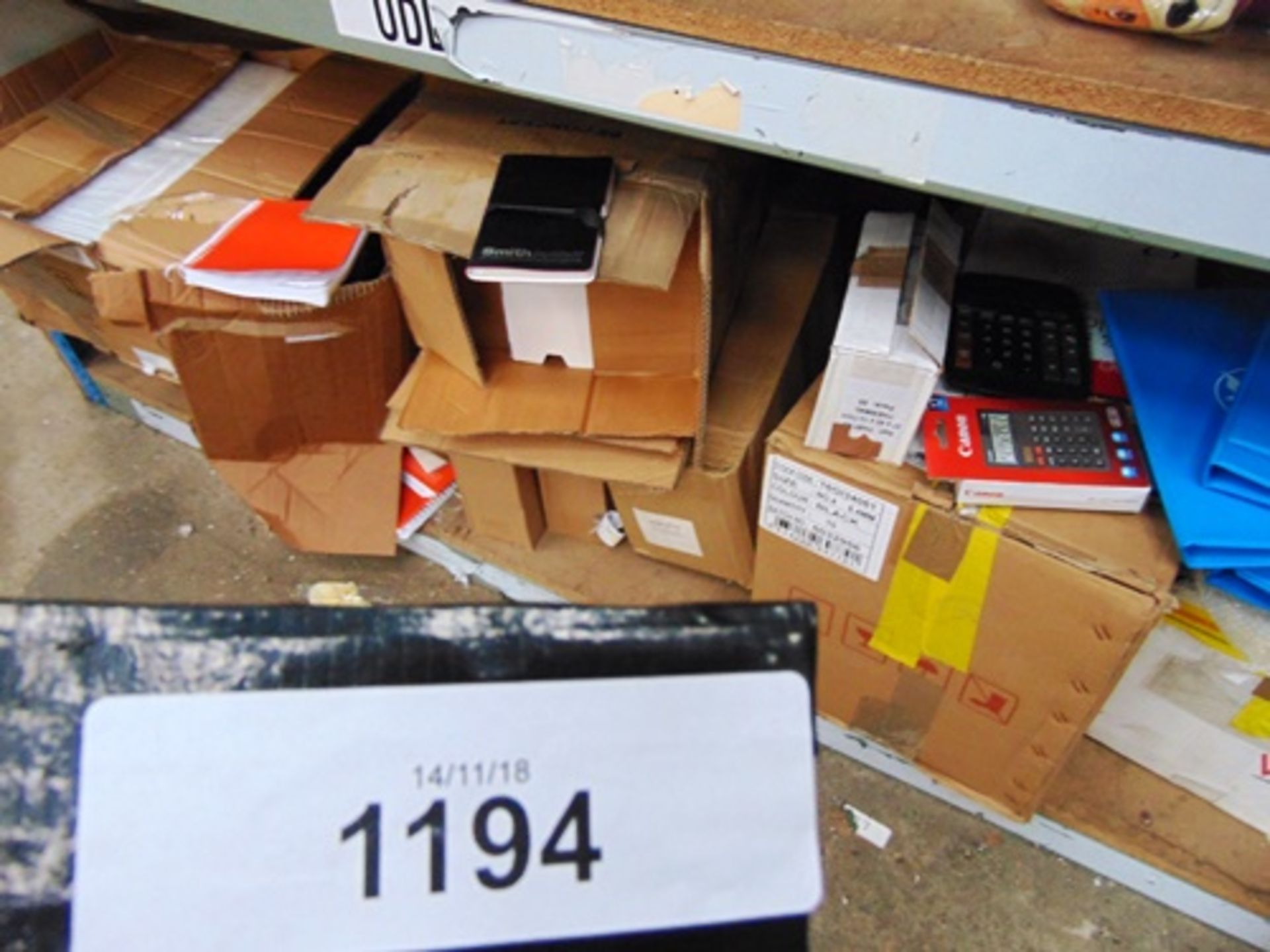 A shelf of stationery items including C4 Peal & Seals envelopes, notepads, calculators etc. -