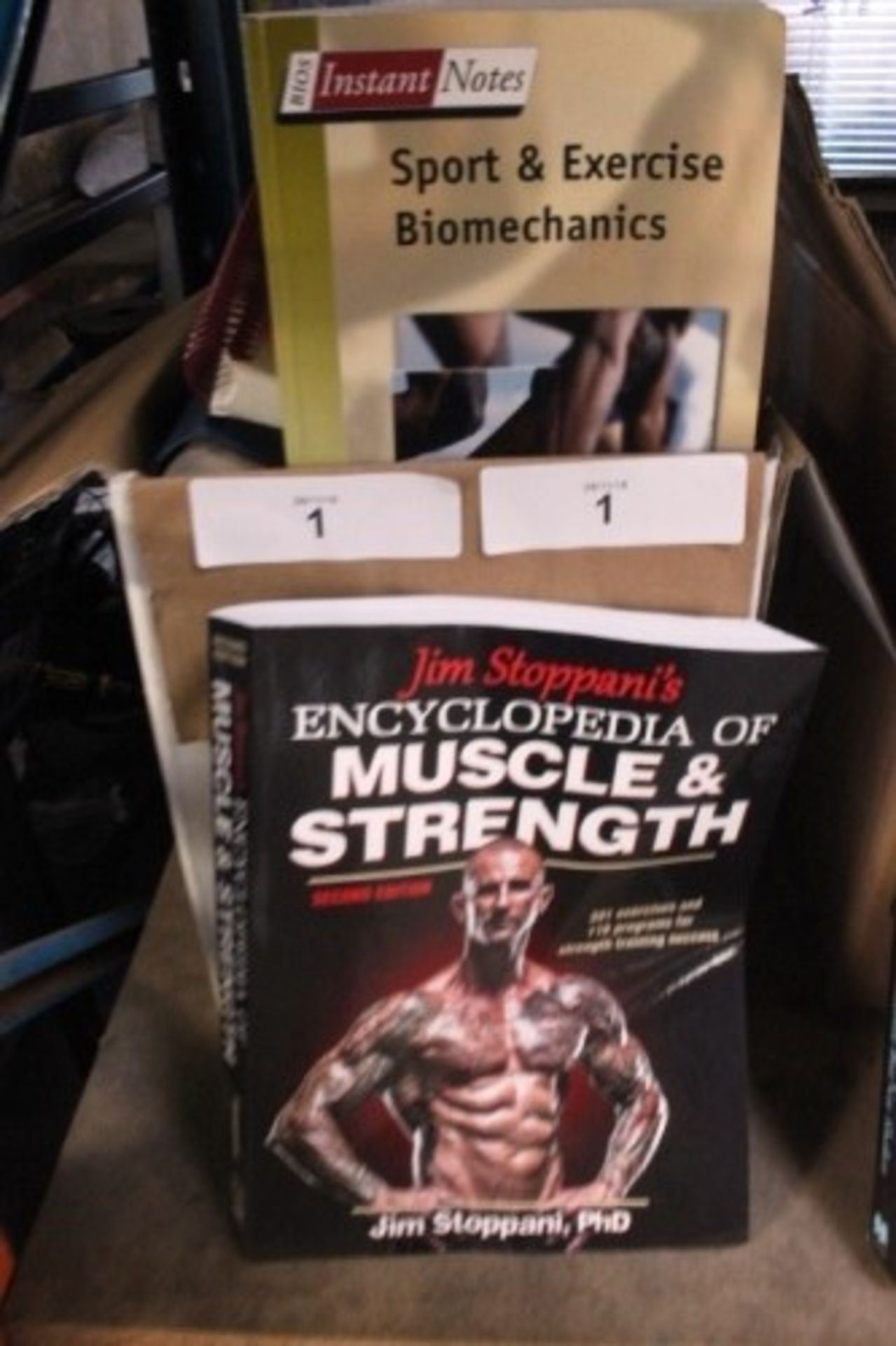A selection of sport and body building related books including Jim Stoppani's encyclopaedia of