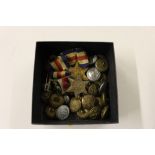 A box containing three WW2 medals and various butt