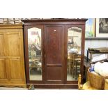 An Edwardian mahogany triple wardrobe