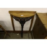 An oak and cast iron console table with ram's head