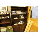 An oak open fronted bookcase with cupboard base