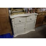 A painted serpentine front side cupboard fitted tw