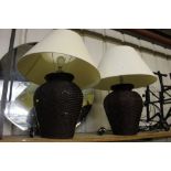 A pair of rattan baluster table lamps and shades