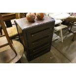 An oak veneered four drawer chest