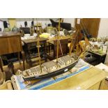 An unfinished wooden model boat