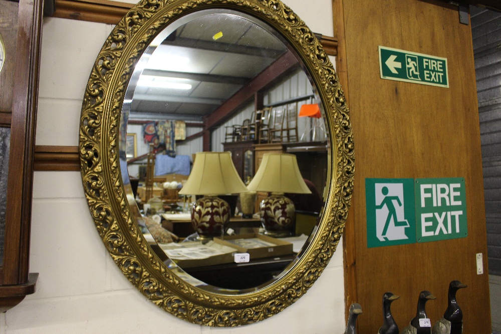 A large gilt and over framed bevelled edge mirror