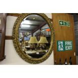 A large gilt and over framed bevelled edge mirror