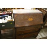 An Edwardian mahogany and inlaid three drawer bure