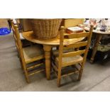 A modern pine circular top kitchen table with two