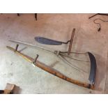A two handled scythe; hay knife and a wooden hay r