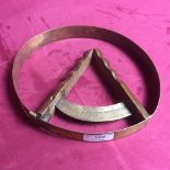 A vintage brass hat measuring tool