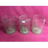 Three large glass candle holders