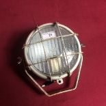 A small white metal spot light, originally from a tractor