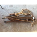 A quantity of old walking sticks and three old ten