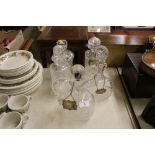 Five various glass decanters, four with labels