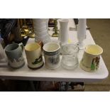 Four various china tankards and a glass tankard