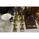 Four pairs of various brass candlesticks