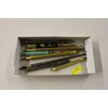 A box of various pens and pencils