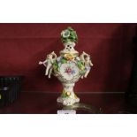 A Naples china floral encrusted and figural mounte